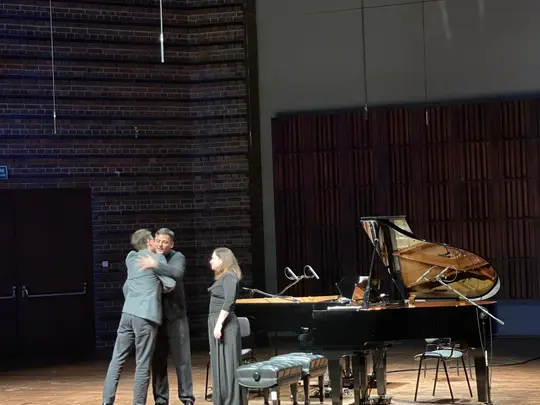 Diana Buffa and Ivan Buffa congratulate Adam Porębski, composer of the piece Mobile for piano for 4 hands
