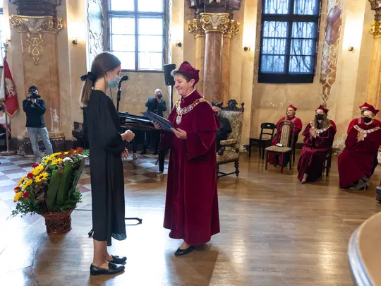 Prorektor ds. studenckich i dydaktyki Akademii Muzycznej, prof. dr hab. Helena Tomaszek-Plewa, wręcza listy gratulacyjne studentom