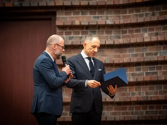 Dr hab. Artur Wr&oacute;bel, prof. AMKL, Przewodniczący Uczelnianej Komisji Wyborczej, wręcza prof. dr. hab. Krystianowi Kiełbowi akt stwierdzający wyb&oacute;r Rektora Akademii Muzycznej im. Karola Lipińskiego we Wrocławiu na kadencję 2024-2028