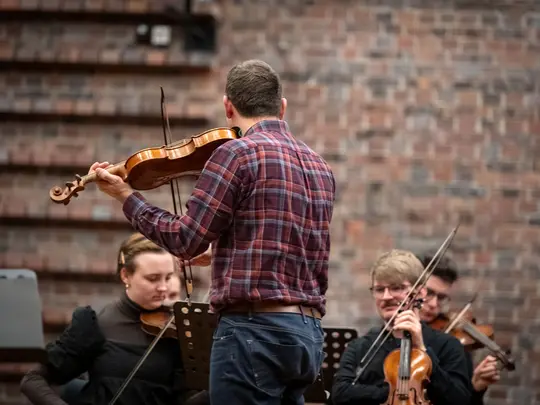 Project coordinator WBB Orchestra and band leader Dr. Paweł Miczka together with orchestra members