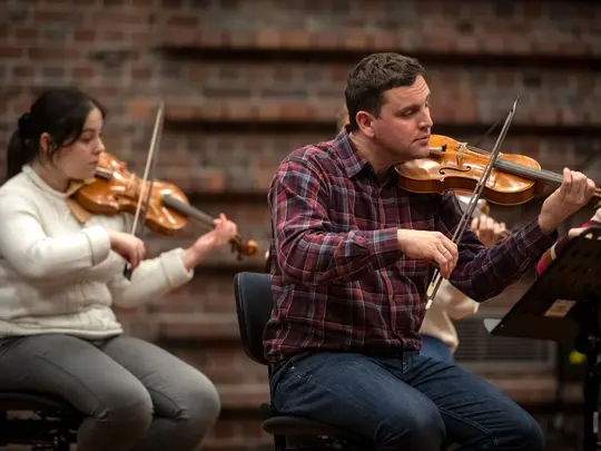 Project coordinator WBB Orchestra and band leader Dr. Paweł Miczka together with orchestra members